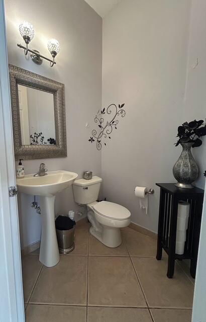 673 Gazetta Way West Palm Beach, FL 33413 - Photo 16 of 35 a bathroom with a toilet sink and mirror