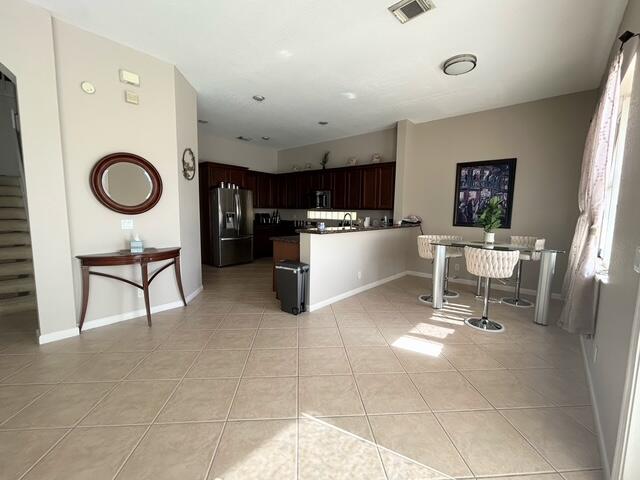 673 Gazetta Way West Palm Beach, FL 33413 - Photo 17 of 35 a kitchen with a table and chairs in it