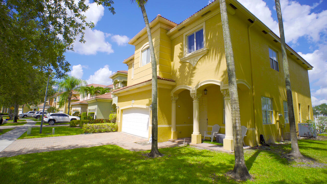 673 Gazetta Way West Palm Beach, FL 33413 - Photo 2 of 35 a view of a building with a yard