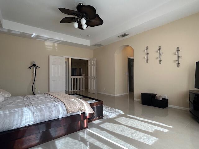 673 Gazetta Way West Palm Beach, FL 33413 - Photo 23 of 35 a bedroom with a bed and a ceiling fan