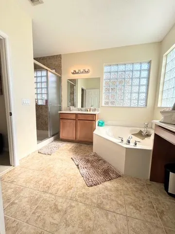 a spacious bathroom with sink and bathtub
