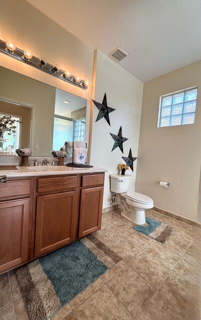 673 Gazetta Way West Palm Beach, FL 33413 - Photo 28 of 35 a bathroom with a granite countertop sink a toilet and a mirror