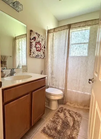 a spacious bathroom with a sink toilet and shower
