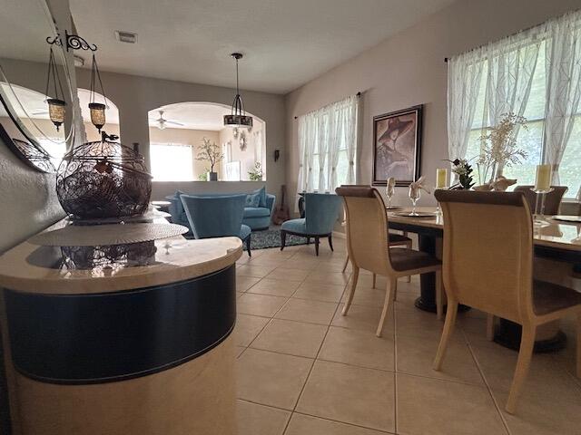 673 Gazetta Way West Palm Beach, FL 33413 - Photo 5 of 35 a living room with furniture a large window and a chandelier