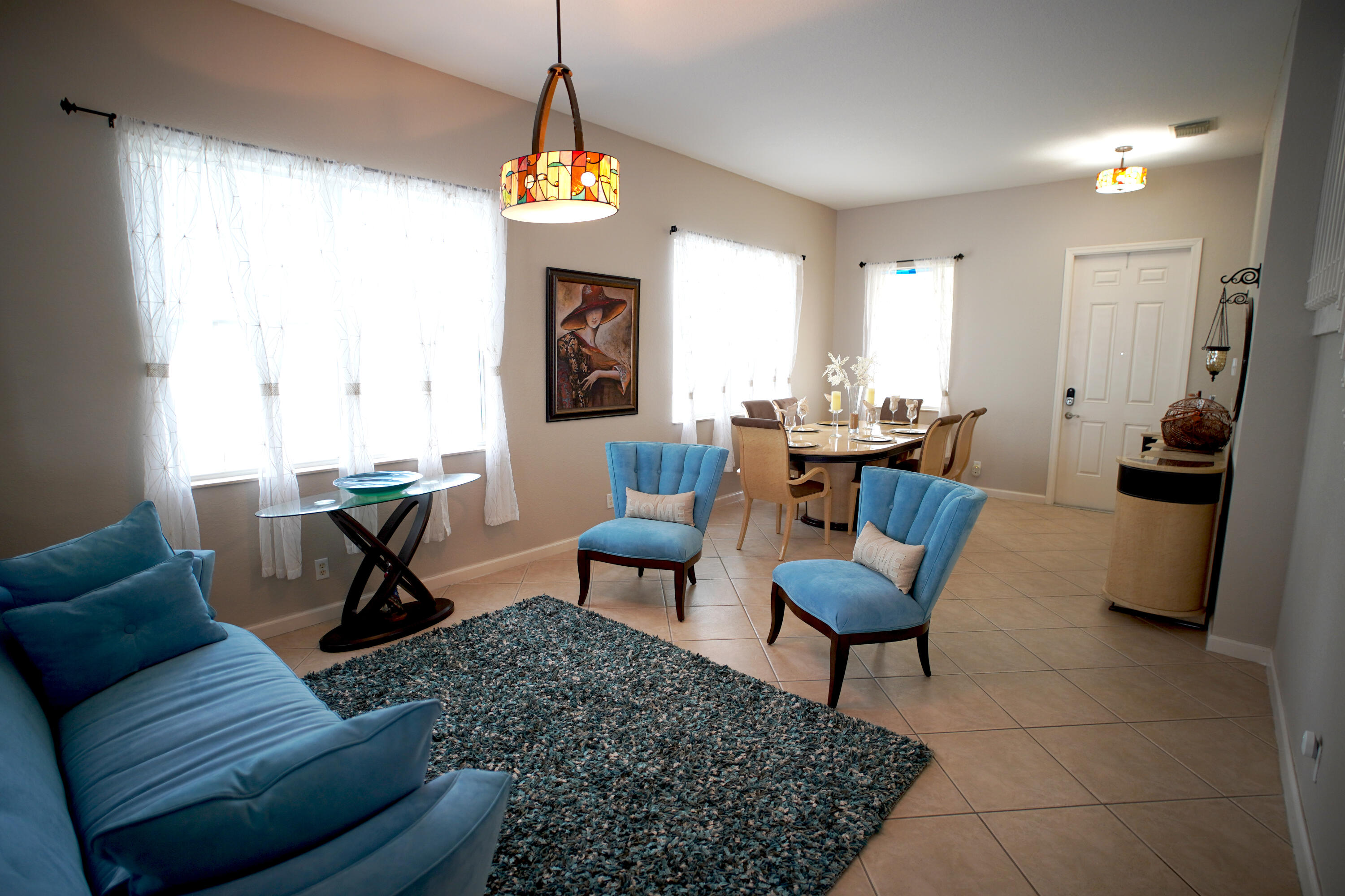 673 Gazetta Way West Palm Beach, FL 33413 - Photo 8 of 35 a living room with furniture and a chandelier