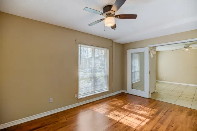 wooden floor in an empty room with a window