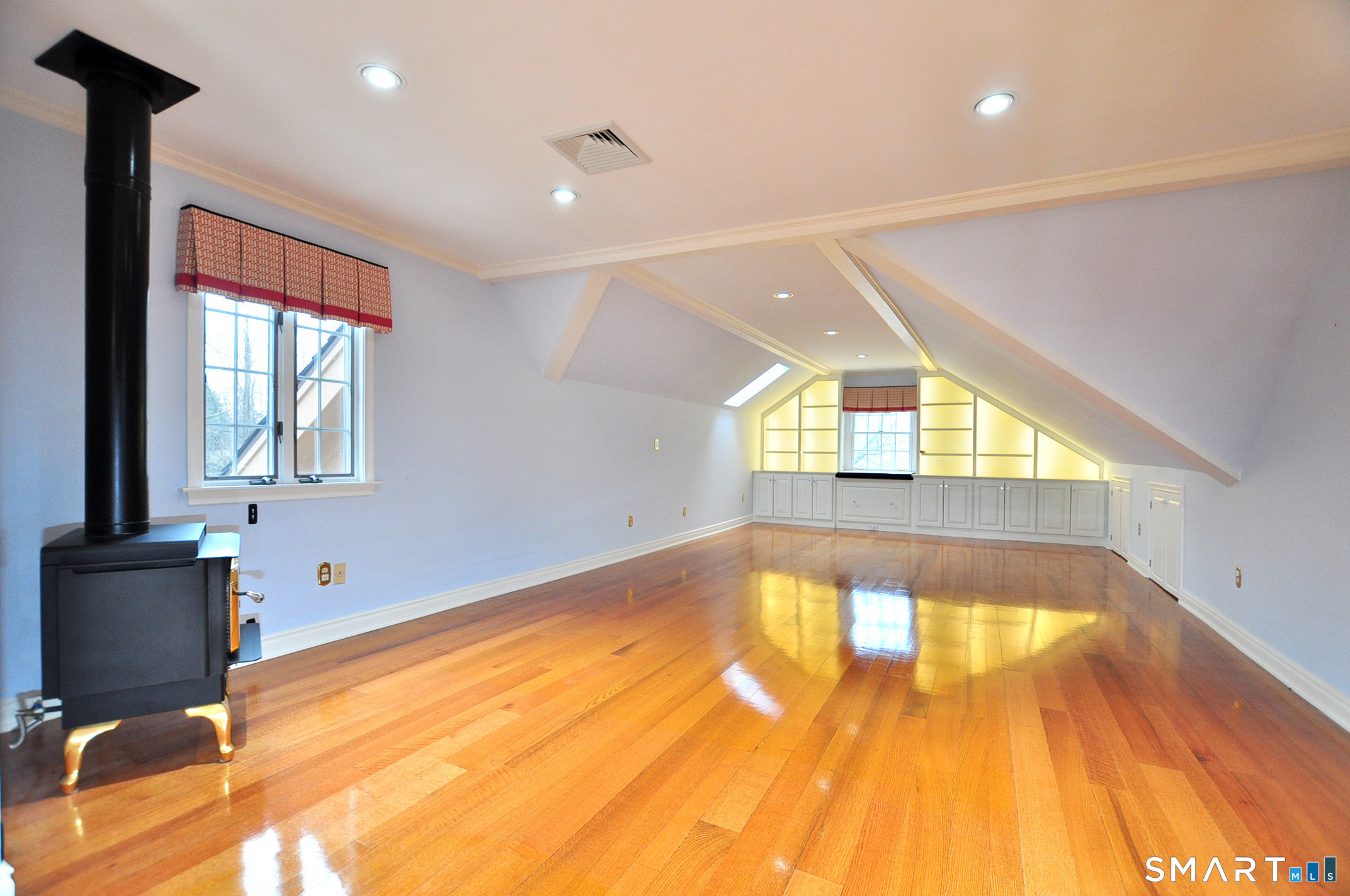 243 Milton Road Goshen, CT 06756 - Photo 15 of 38 The spacious Primary Bedroom is located on the second floor and features built-in lit shelving, a propane fireplace and a Brown security safe in the closet.