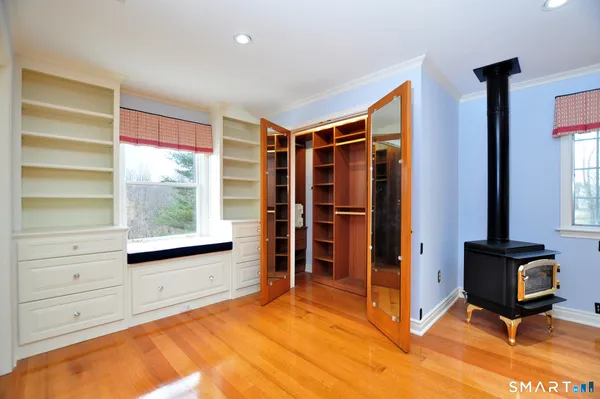 a view of an empty room with a fireplace and a window