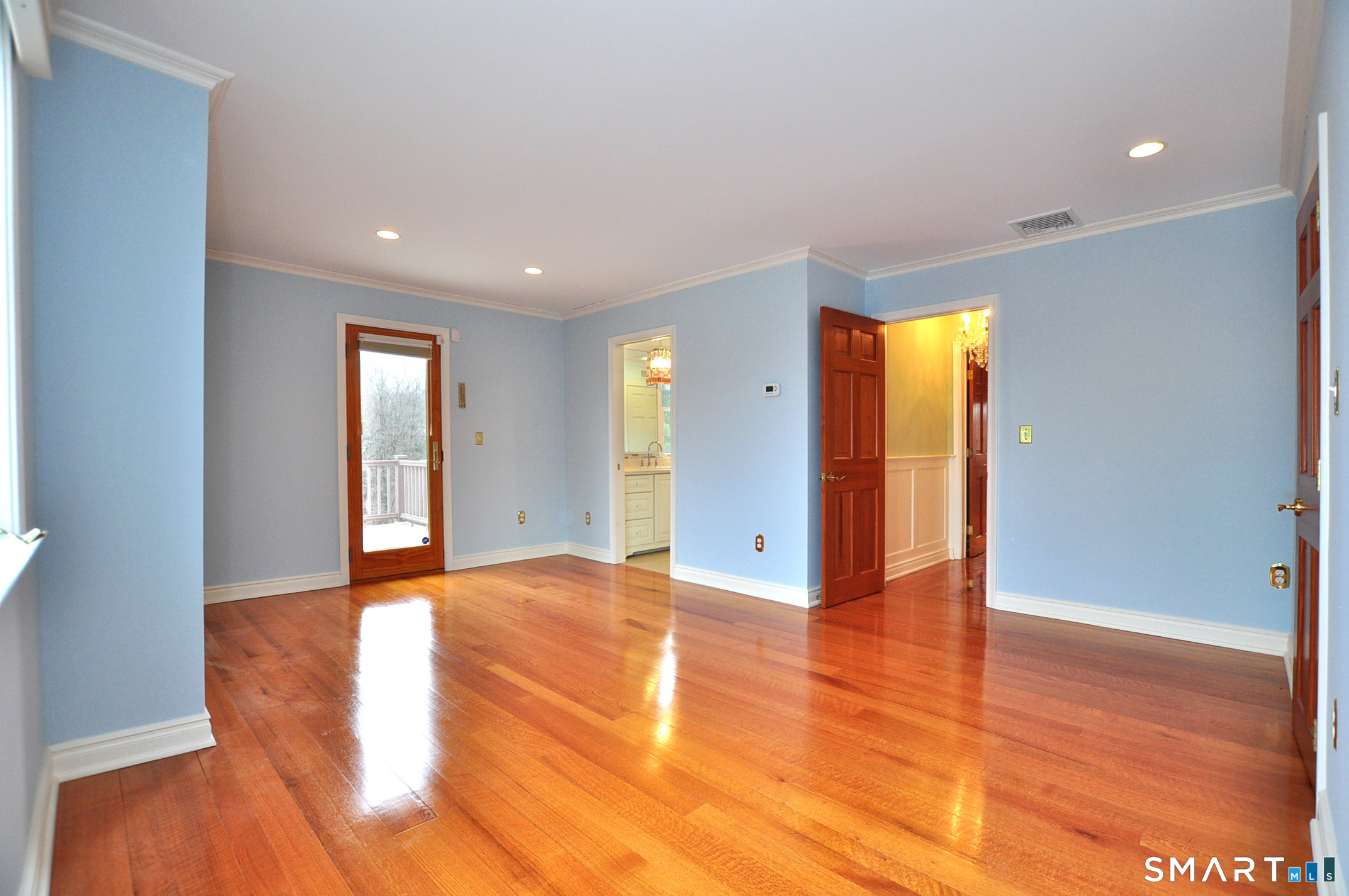 243 Milton Road Goshen, CT 06756 - Photo 19 of 38 Second-floor Bedroom has large closet and exterior door leading to an upper-level balcony deck overlooking lower-level deck and rear yard.