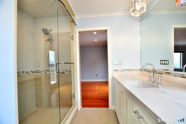 a bathroom with a tub sink and mirror