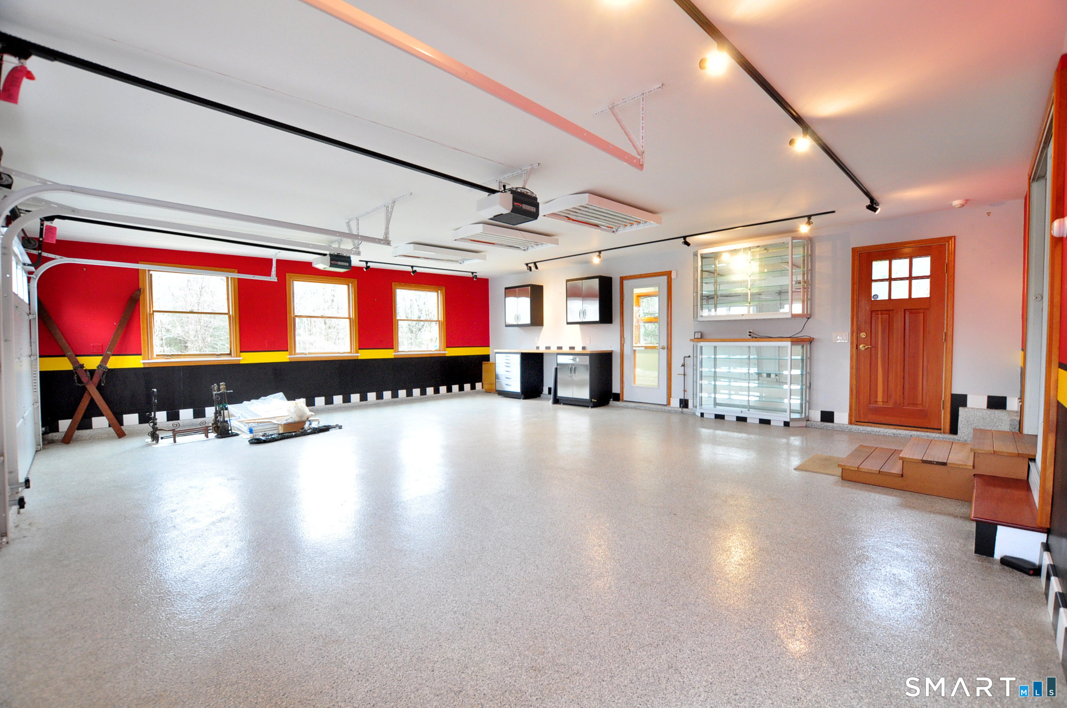 243 Milton Road Goshen, CT 06756 - Photo 24 of 38 This home features five garage bays with overhead doors. Several bays have radiant heat in floor. This bay features overhead lighting to spotlight car collection and built-in cabinets to showcase trophies and other prized possessions.