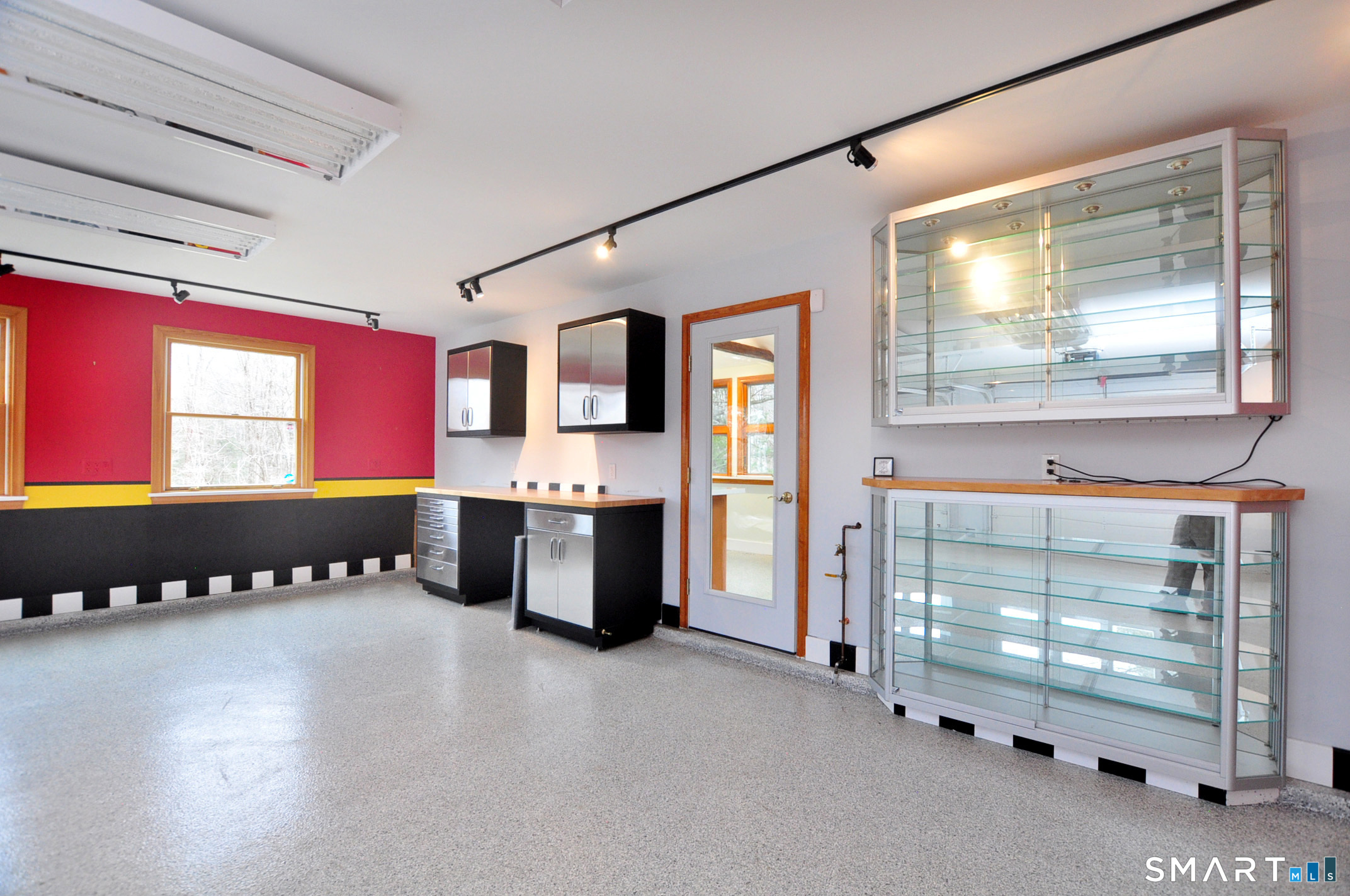 243 Milton Road Goshen, CT 06756 - Photo 25 of 38 This home features five garage bays with overhead doors. Several bays have radiant heat in floor. This bay features overhead lighting to spotlight car collection and built-in cabinets to showcase trophies and other prized possessions.