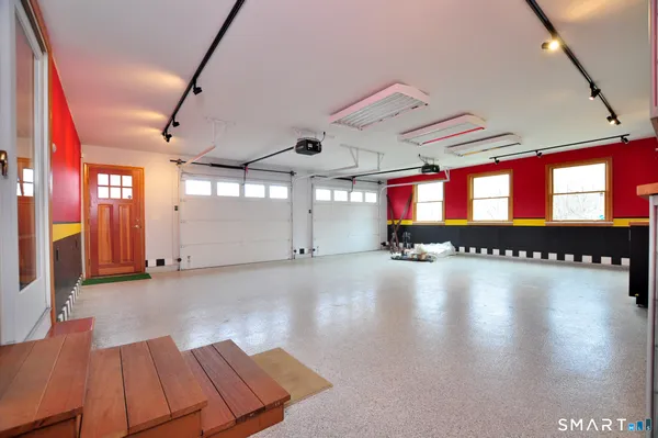 a room with lot of large windows and wooden floor