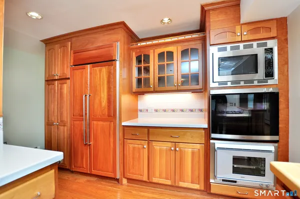 a kitchen with stainless steel appliances granite countertop a stove and a microwave