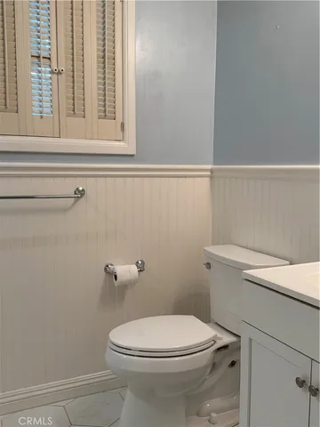 a white toilet sitting next to a window