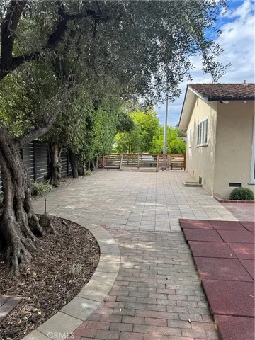 a backyard of a house with plants and trees