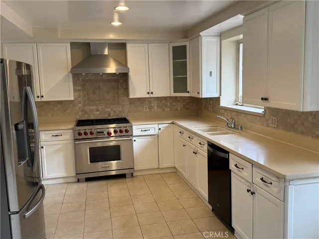 a kitchen with a stove sink and refrigerator