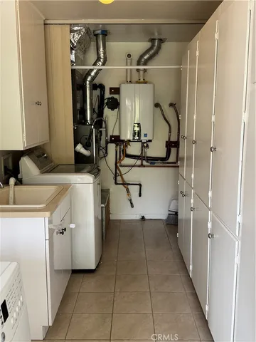 a storage utility room with two washing machine