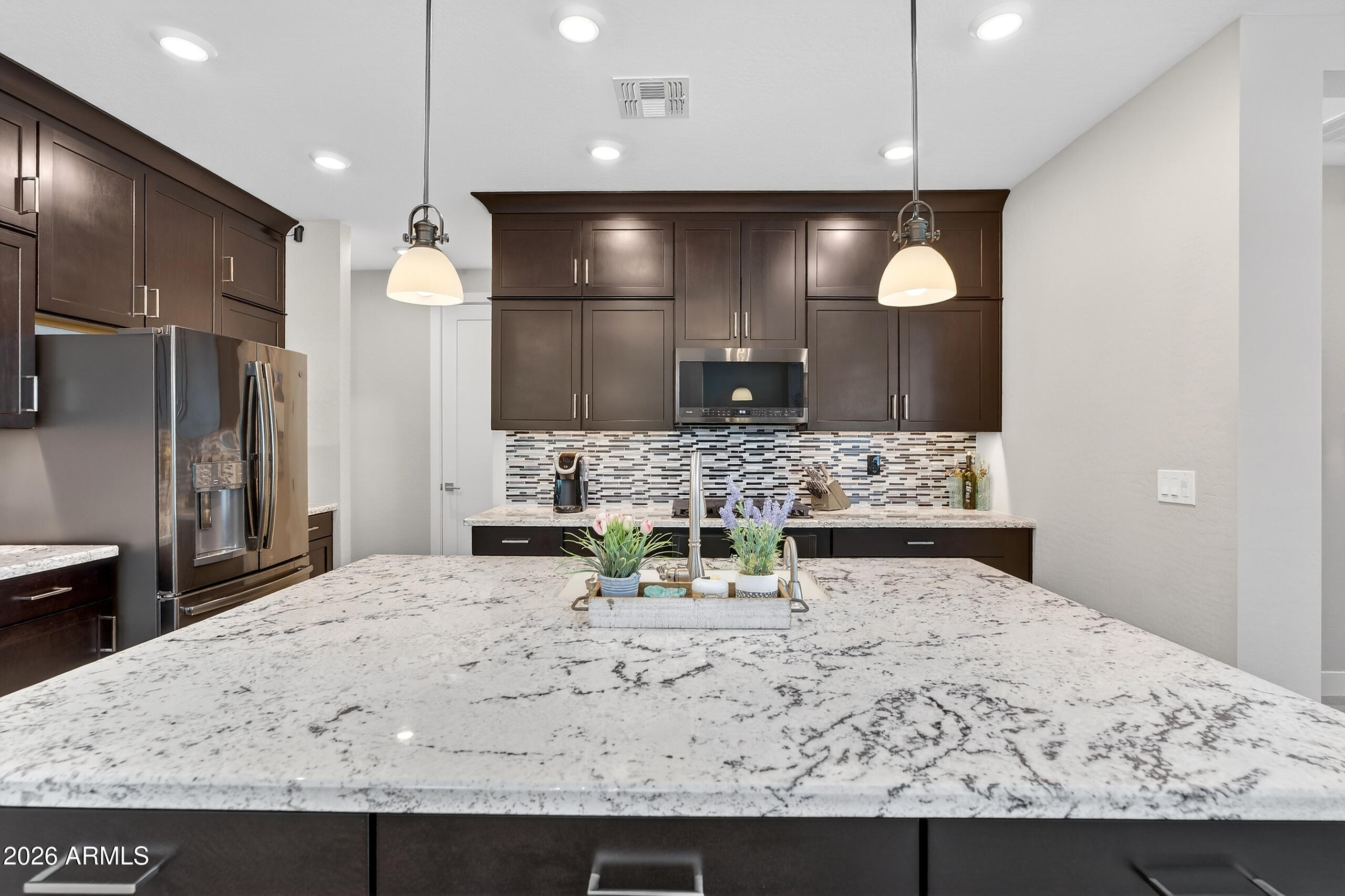 3855 South McQueen Road, Unit 59 Chandler, AZ 85286 - Photo 13 of 56 a view of kitchen with kitchen island a sink stainless steel appliances and cabinets