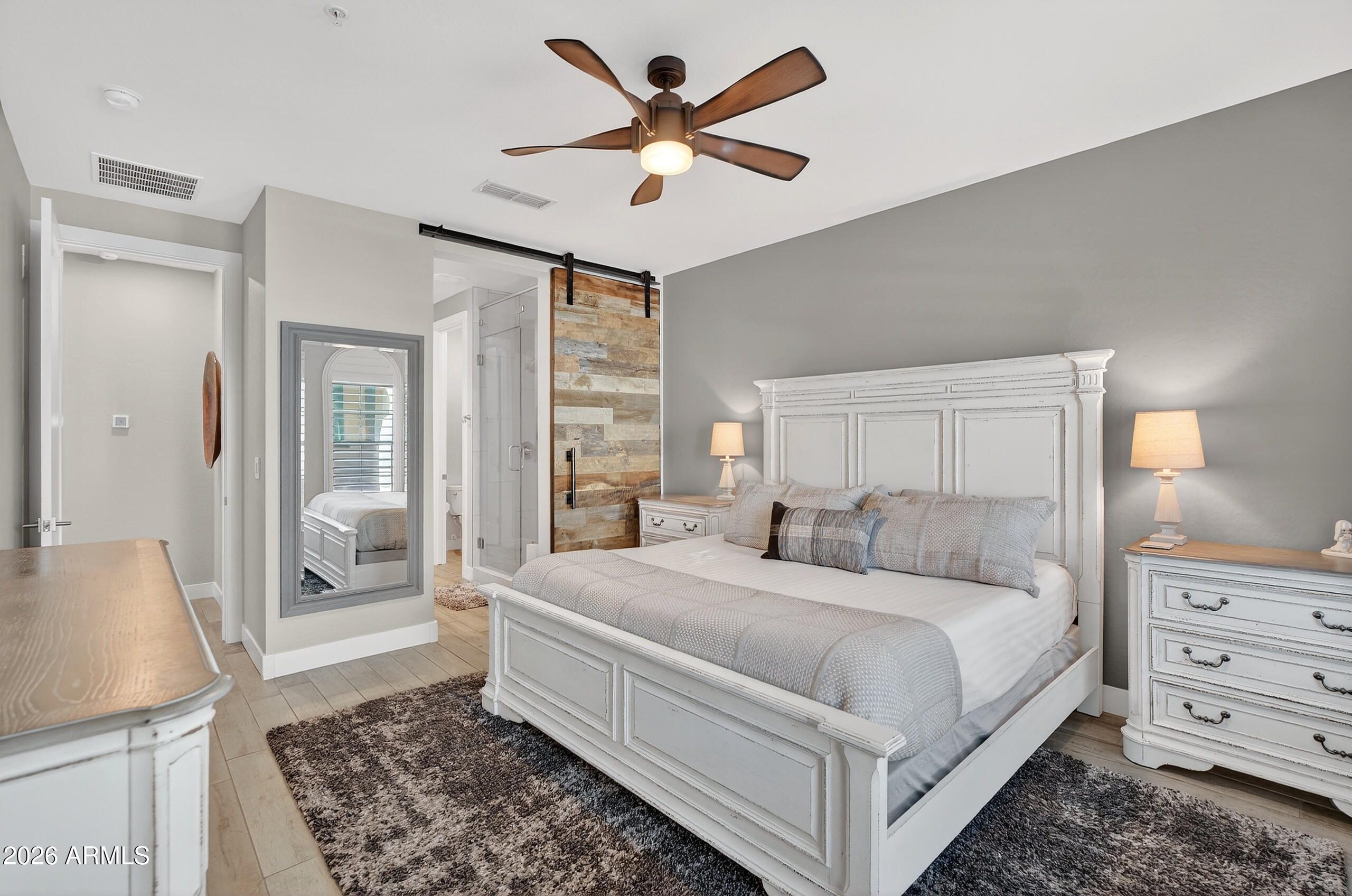 3855 South McQueen Road, Unit 59 Chandler, AZ 85286 - Photo 21 of 56 a bedroom with a large bed and a chandelier fan