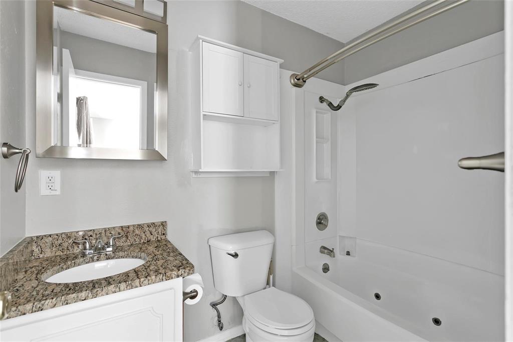 6104 Kelly Elliott Road Arlington, TX 76001 - Photo 5 of 25 a bathroom with a sink toilet and shower