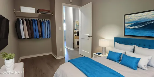 a bedroom with furniture and a closet