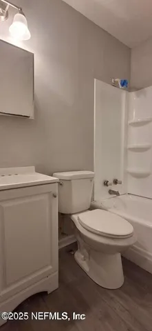a white toilet sitting next to a bathroom sink