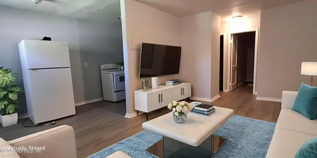 a living room with furniture and a flat screen tv