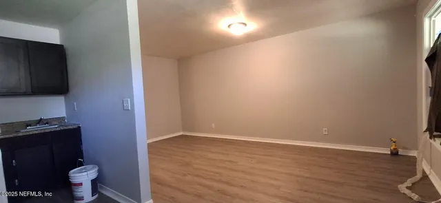 a view of bathroom with toilet a sink and a mirror