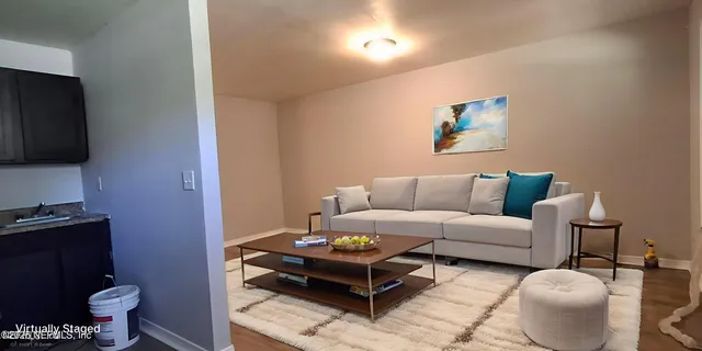 a living room with furniture and a flat screen tv