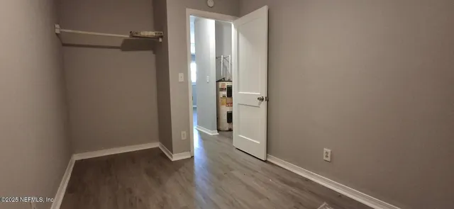 a view of a room with wooden floor