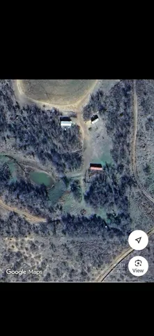 a view of a yard with wooden fence