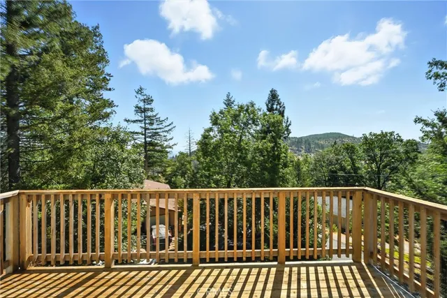 a balcony with wooden floor and fence