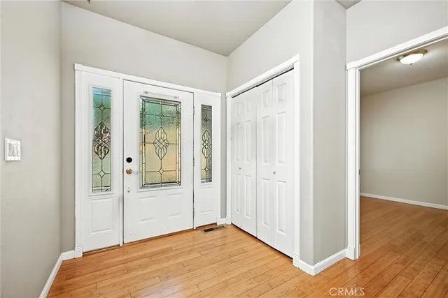 a view of a room with wooden floor and cabinet