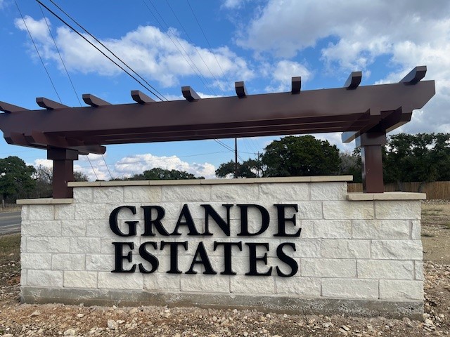 110 Mathew Street Bertram, TX 78605 - Photo 5 of 8 a view of outdoor space with signage and flags