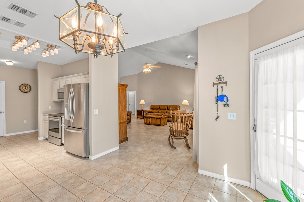225 Los Cedros Loop Kerrville, TX 78028 - Photo 5 of 27 a view of a livingroom with kitchen and chandelier