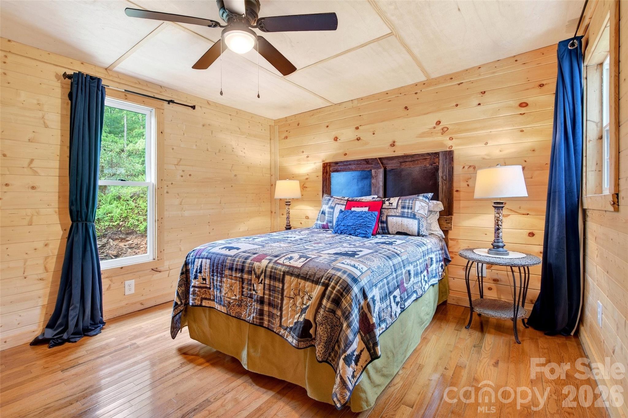 227 Locust Cove Road Marion, NC 28752 - Photo 11 of 34 a bedroom with a bed and a large window