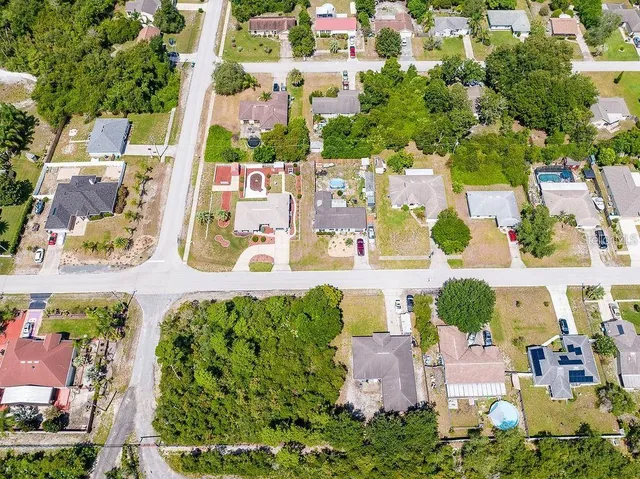 an aerial view of residential houses with outdoor space