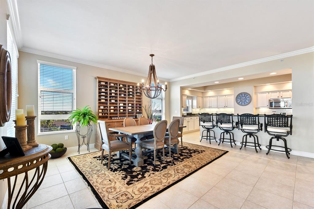 3333 Sunset Key Circle, Unit 407 Punta Gorda, FL 33955 - Photo 17 of 78 a view of a dining room and livingroom with furniture wooden floor and a rug