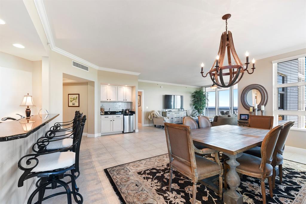 3333 Sunset Key Circle, Unit 407 Punta Gorda, FL 33955 - Photo 18 of 78 a dining room with furniture a chandelier and wooden floor