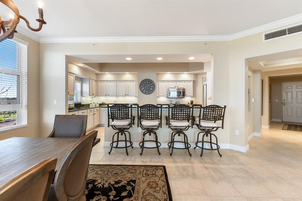 3333 Sunset Key Circle, Unit 407 Punta Gorda, FL 33955 - Photo 19 of 78 a large kitchen with a table and chairs