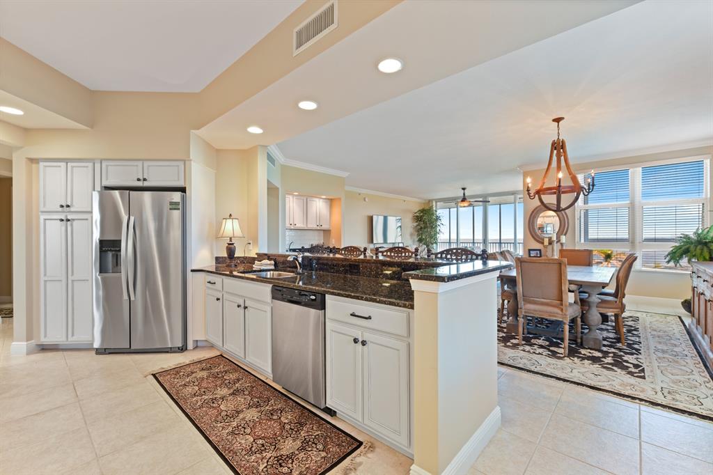 3333 Sunset Key Circle, Unit 407 Punta Gorda, FL 33955 - Photo 23 of 78 a kitchen with stainless steel appliances kitchen island granite countertop a refrigerator and a sink