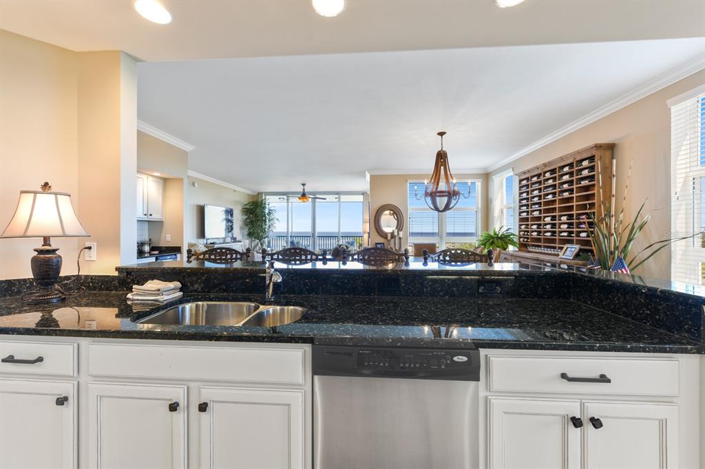 3333 Sunset Key Circle, Unit 407 Punta Gorda, FL 33955 - Photo 24 of 78 a kitchen with granite countertop a sink a stove and cabinets