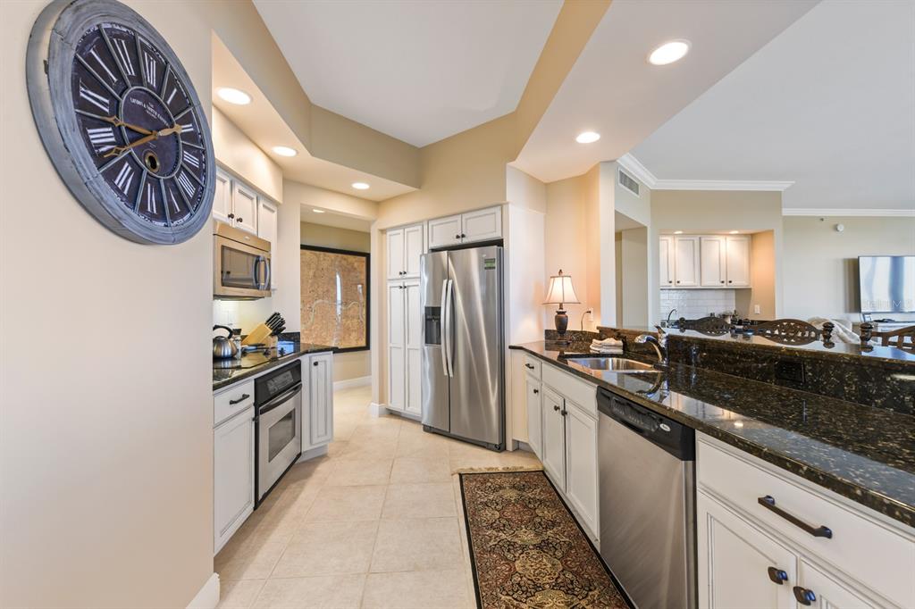 3333 Sunset Key Circle, Unit 407 Punta Gorda, FL 33955 - Photo 26 of 78 a kitchen with granite countertop a stove and cabinets