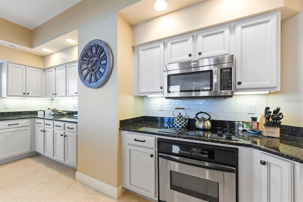 3333 Sunset Key Circle, Unit 407 Punta Gorda, FL 33955 - Photo 28 of 78 a kitchen with stainless steel appliances granite countertop white cabinets and a stove