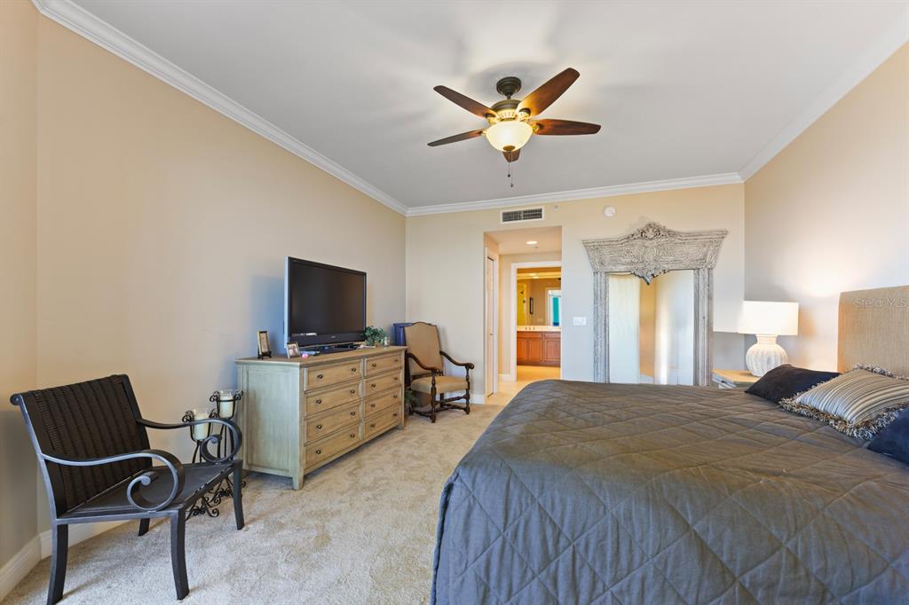 3333 Sunset Key Circle, Unit 407 Punta Gorda, FL 33955 - Photo 31 of 78 a spacious bedroom with a bed and chair