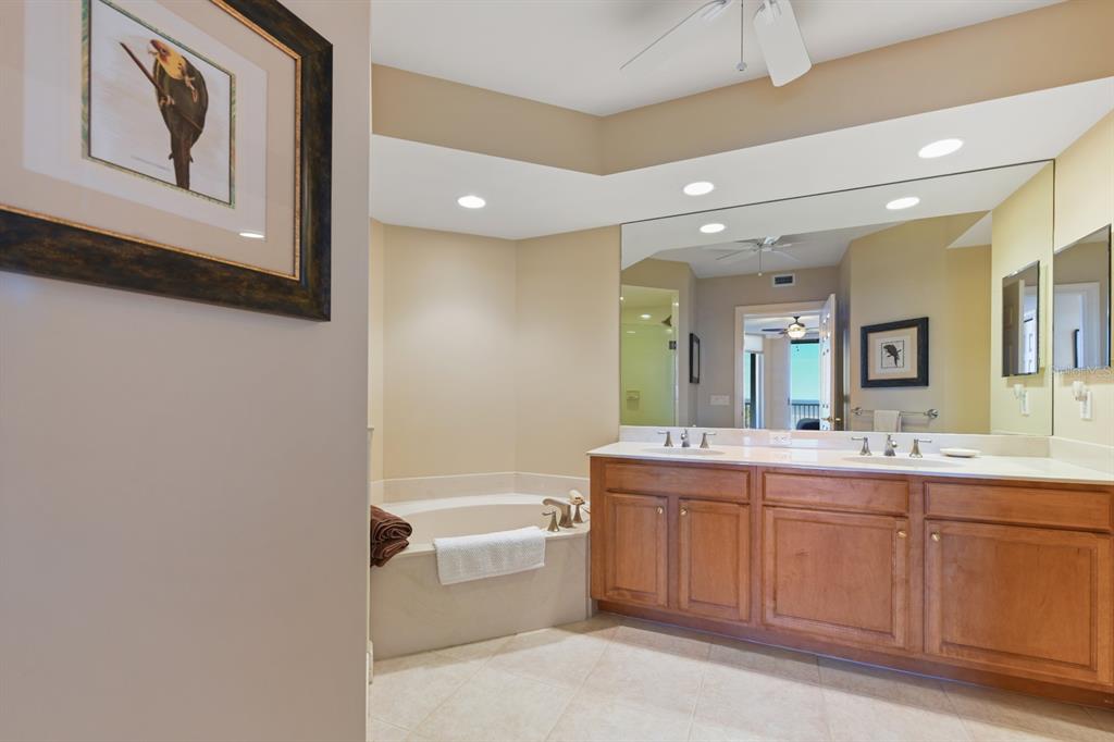 3333 Sunset Key Circle, Unit 407 Punta Gorda, FL 33955 - Photo 32 of 78 a bathroom with a tub sink shower and mirror