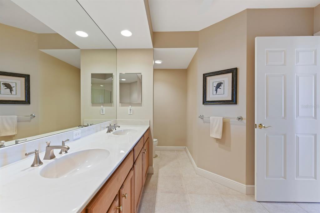3333 Sunset Key Circle, Unit 407 Punta Gorda, FL 33955 - Photo 34 of 78 a bathroom with a double vanity sink a mirror and a shower