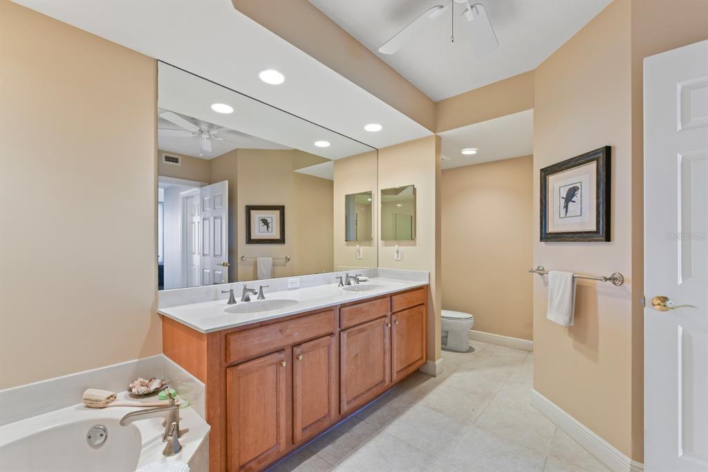3333 Sunset Key Circle, Unit 407 Punta Gorda, FL 33955 - Photo 35 of 78 a spacious bathroom with a double vanity sink a mirror and a shower