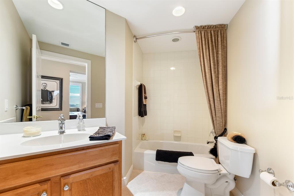 3333 Sunset Key Circle, Unit 407 Punta Gorda, FL 33955 - Photo 38 of 78 a bathroom with a sink a toilet a mirror and shower